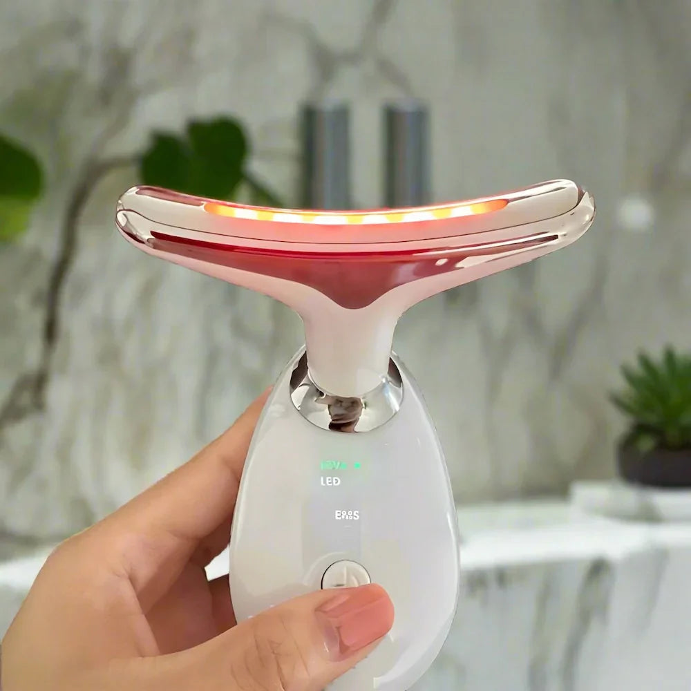 LED neck massager glowing red during anti ageing light therapy