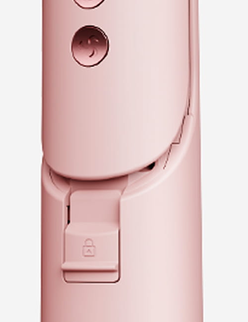 Close-up of a pink electronic device with a focus on a button and latch.