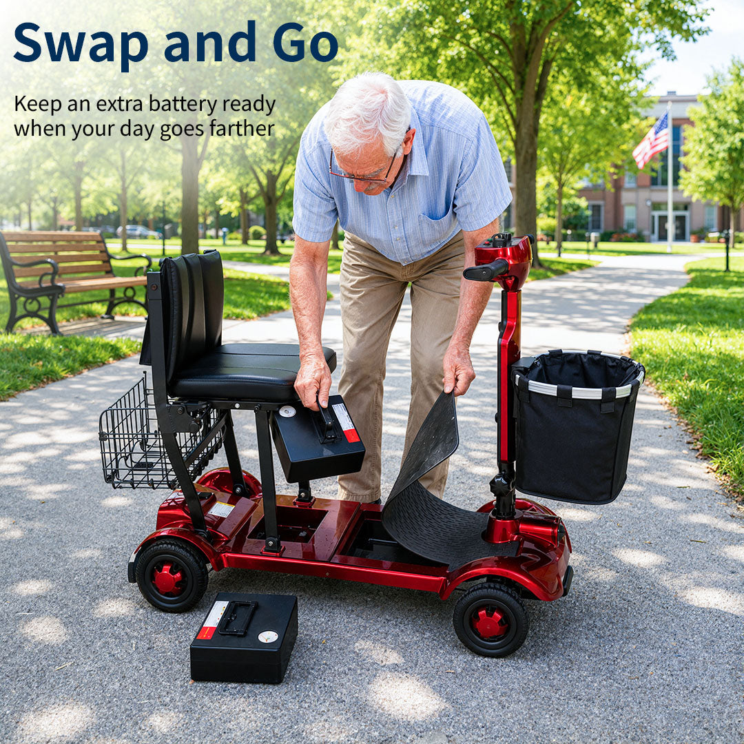 Senior man swapping the battery on a shiny red mobility scooter parked on a sunny park path.