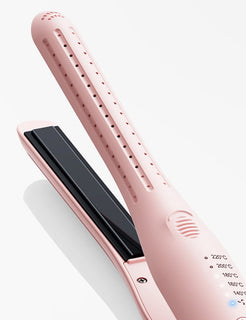 Rose gold hair straightener on a white background