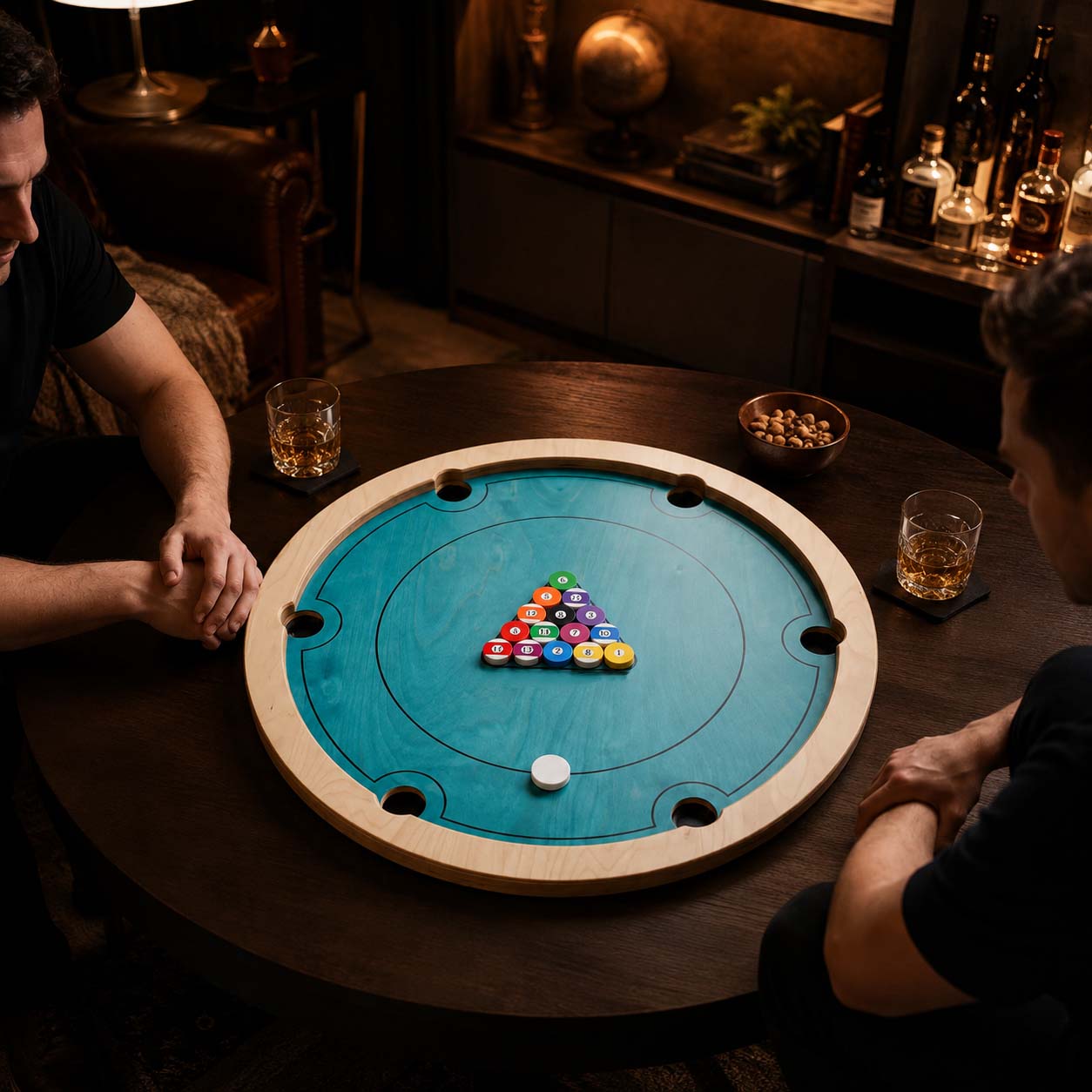 Friends competing with chips and a striker on the rotating mini billiards board