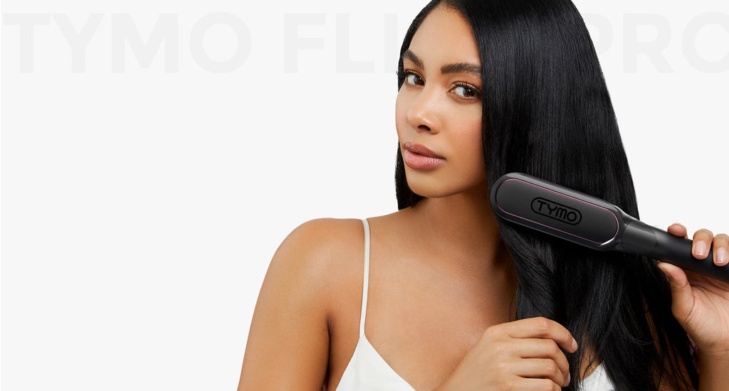 TYMO FLIPRO hair comb straightener gliding through thick, shiny black hair