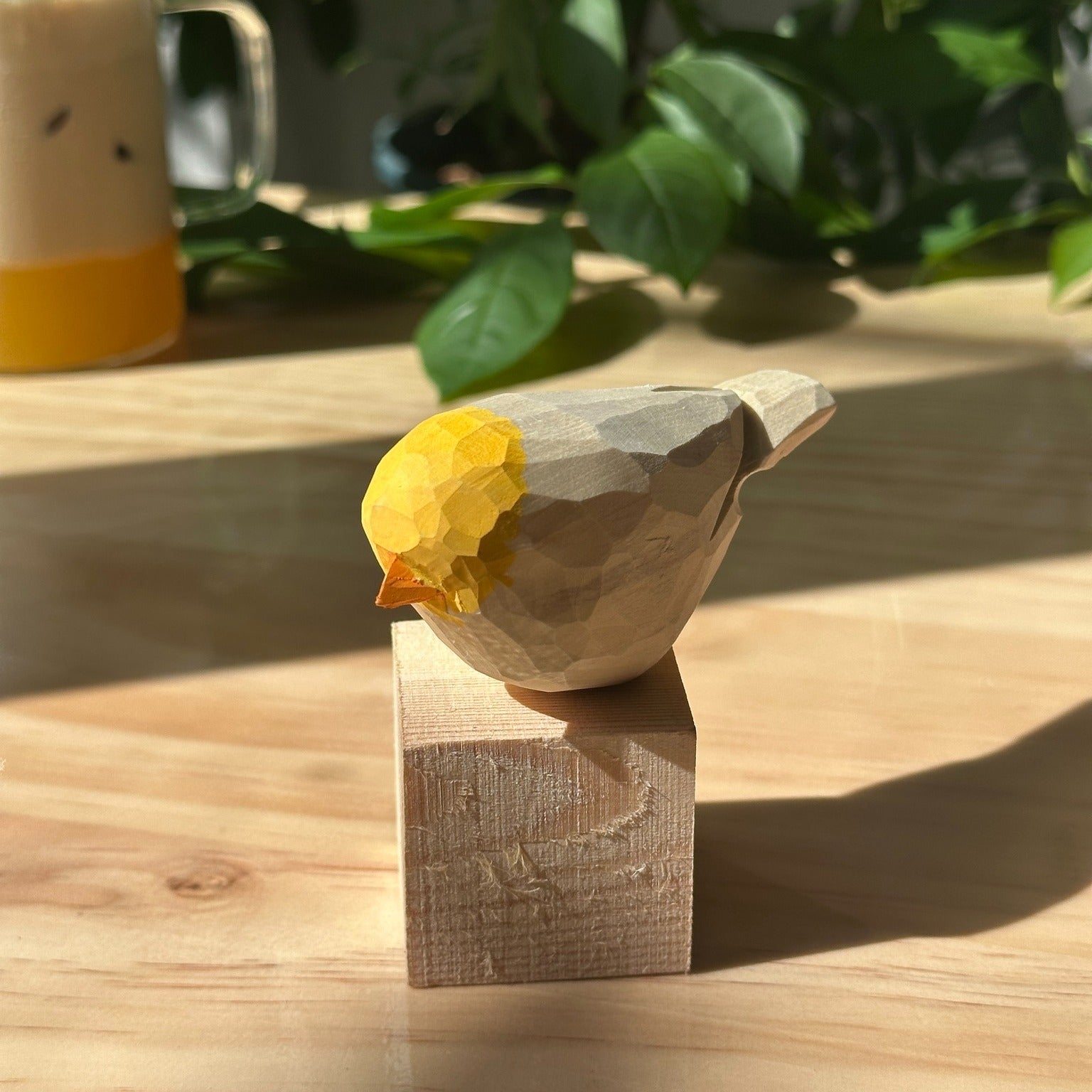 Instagram post with the caption: Wait—look at the sunlight catching that real wood grain… ☀️🐦
Ev...