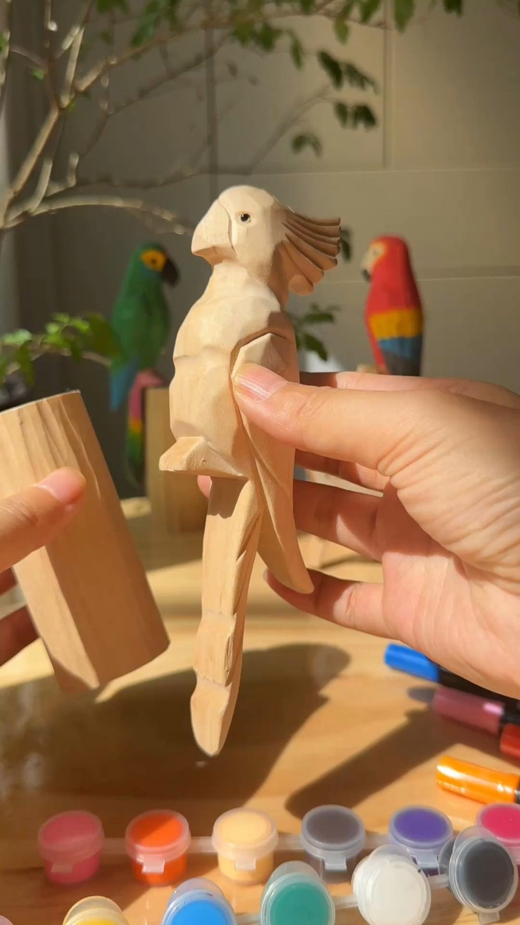 Instagram post with the caption: A little sunshine, a wooden parrot, and nowhere to rush. ☀️🦜🎨
...