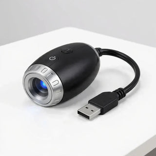 StarVeil AuraDrift Light matte black body with USB cable on white background, compact dreamy star ceiling light design